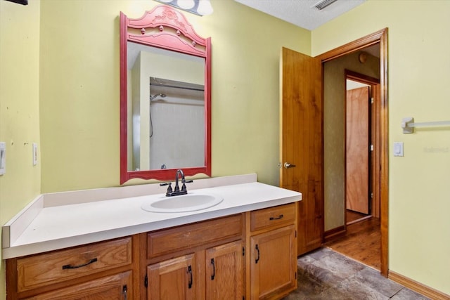 bathroom with a textured ceiling and vanity