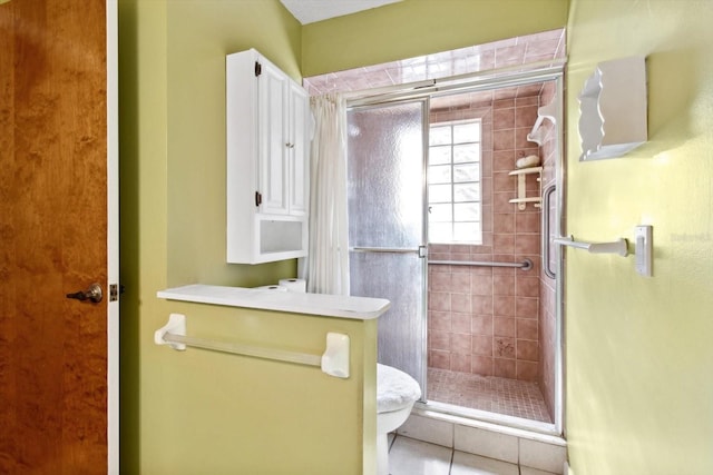 bathroom with toilet, tile patterned floors, and an enclosed shower