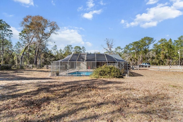 view of yard featuring a lanai and a rural view