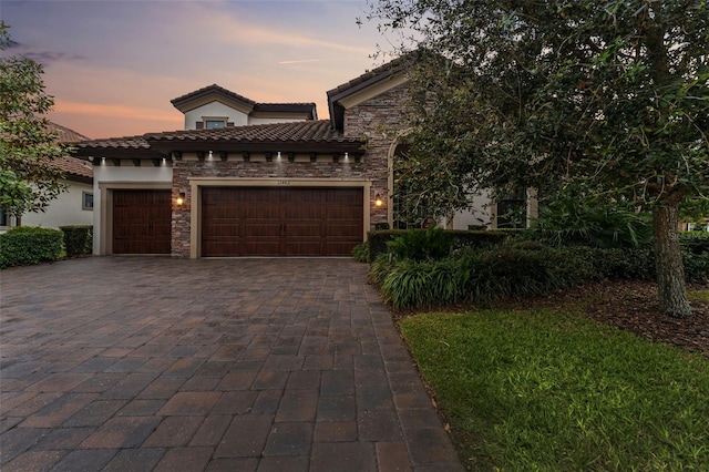 mediterranean / spanish-style house with a garage