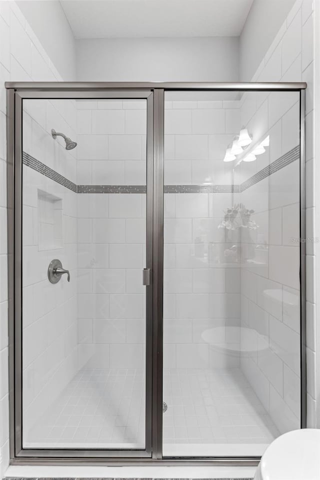 bathroom featuring a shower with shower door