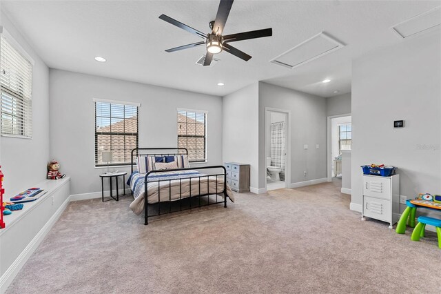 carpeted bedroom with ceiling fan and connected bathroom