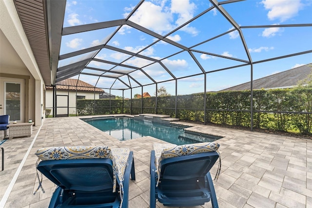 view of pool featuring a patio area and glass enclosure