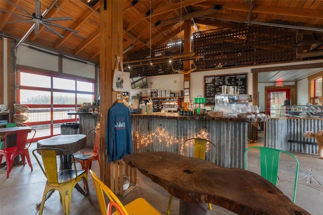 dining area with ceiling fan, concrete floors, wooden ceiling, and lofted ceiling with beams