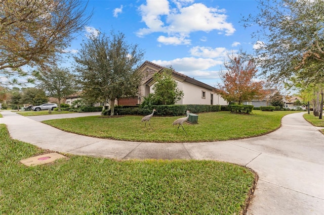 view of side of home with a yard