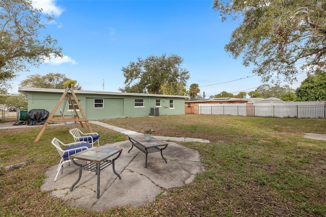 back of property featuring a patio area, cooling unit, and a yard