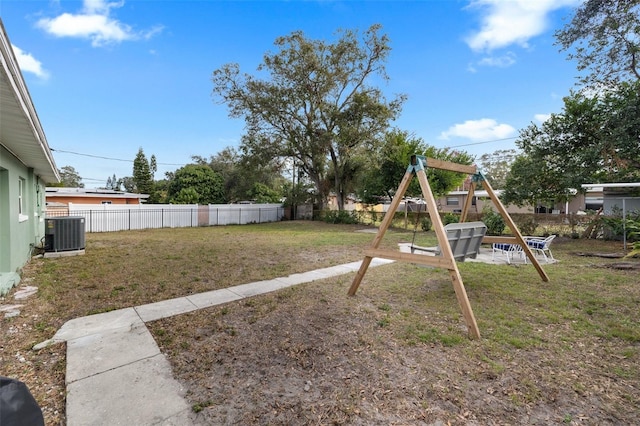 view of yard with a playground and central AC