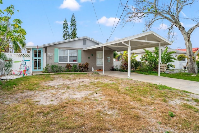 single story home featuring a front lawn and a carport