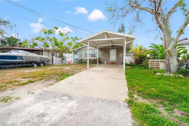 bungalow-style house featuring a front lawn and a carport