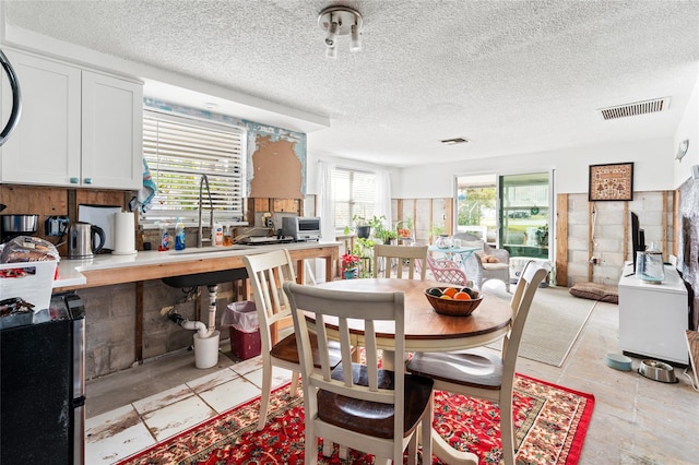 dining area with a textured ceiling