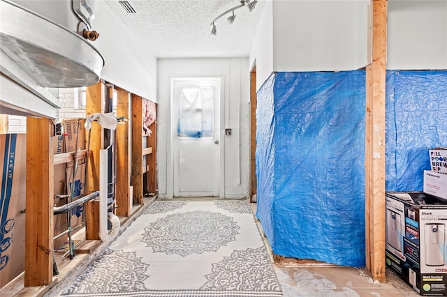 interior space with a textured ceiling