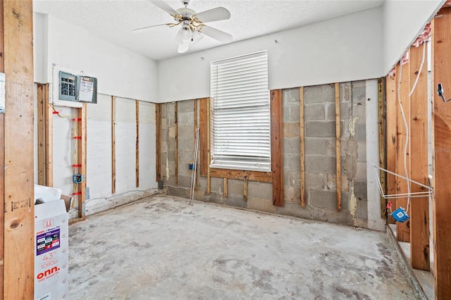 interior space with ceiling fan and a textured ceiling