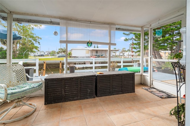 sunroom / solarium with a wealth of natural light and a water view