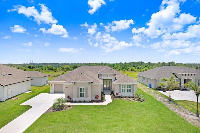 mediterranean / spanish-style home featuring a garage and a front yard