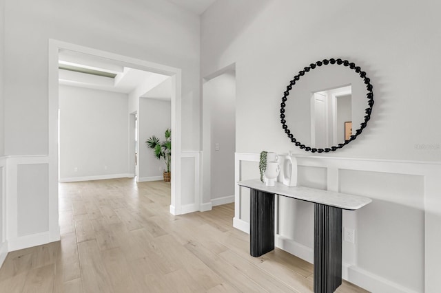 corridor with light hardwood / wood-style floors