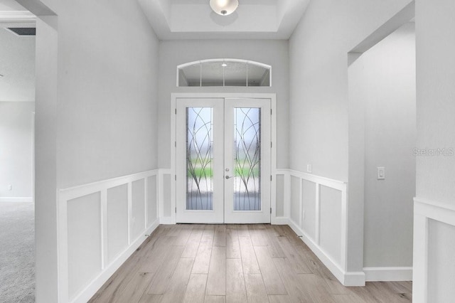 entryway featuring french doors and light hardwood / wood-style flooring