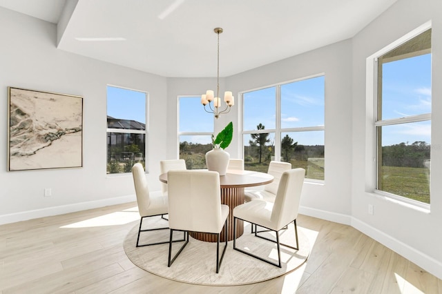 dining space featuring a chandelier and light hardwood / wood-style flooring