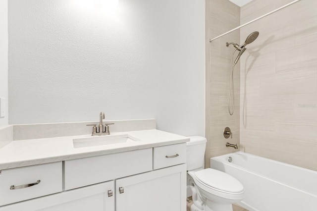 full bathroom with vanity, tiled shower / bath, and toilet