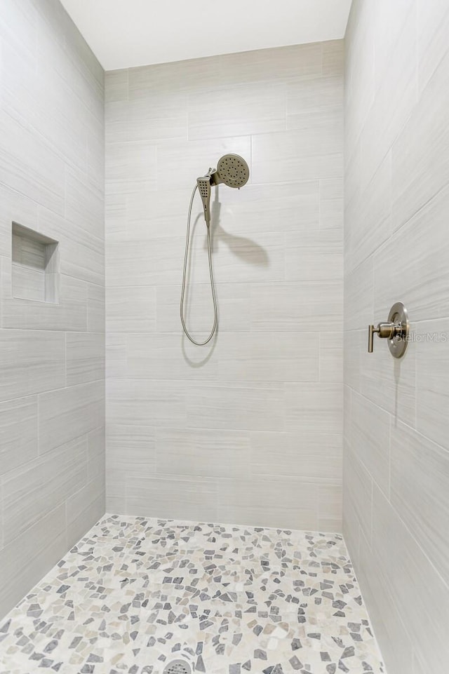 bathroom with a tile shower