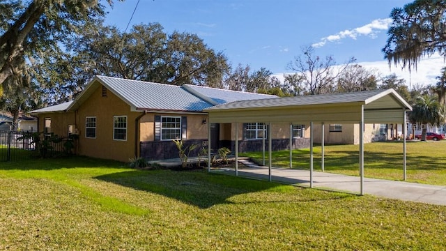 ranch-style house featuring a front lawn and a carport