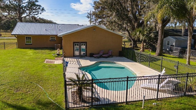 view of swimming pool featuring a lawn and a patio area