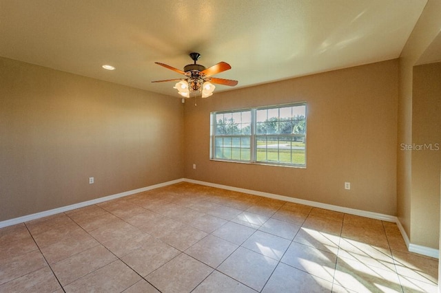 empty room featuring ceiling fan and light tile patterned flooring