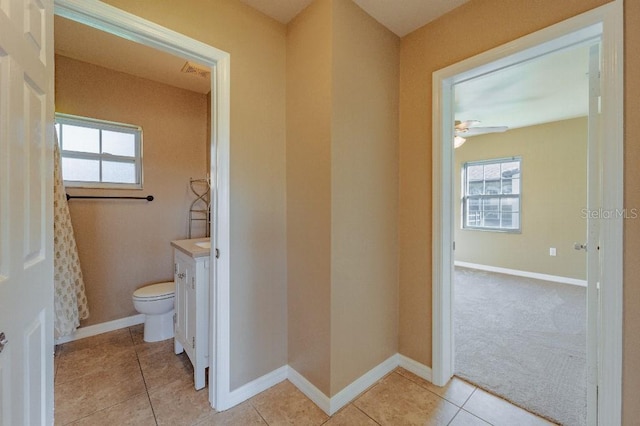 bathroom featuring toilet, ceiling fan, tile patterned floors, and vanity