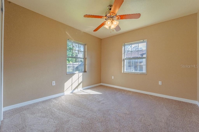 unfurnished room with ceiling fan, plenty of natural light, and light carpet