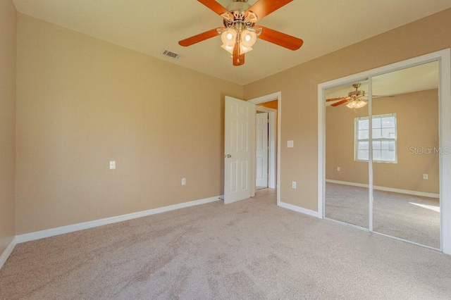 unfurnished bedroom featuring ceiling fan, carpet, and a closet