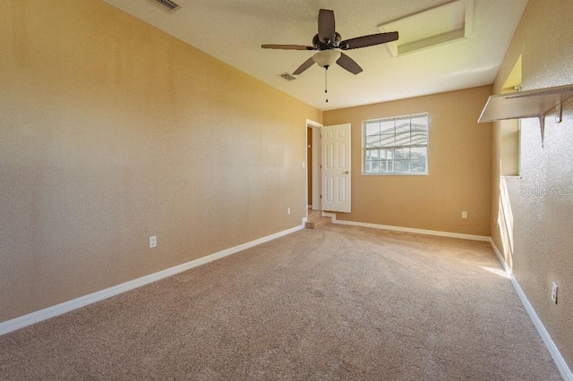 spare room featuring ceiling fan and carpet floors