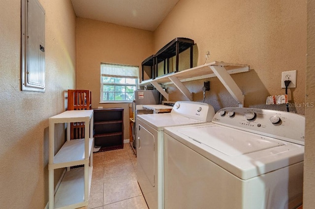 washroom with separate washer and dryer, electric panel, gas water heater, and light tile patterned flooring