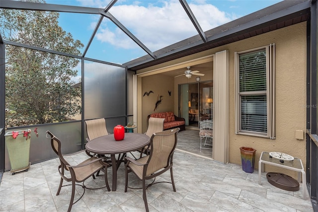 sunroom featuring ceiling fan