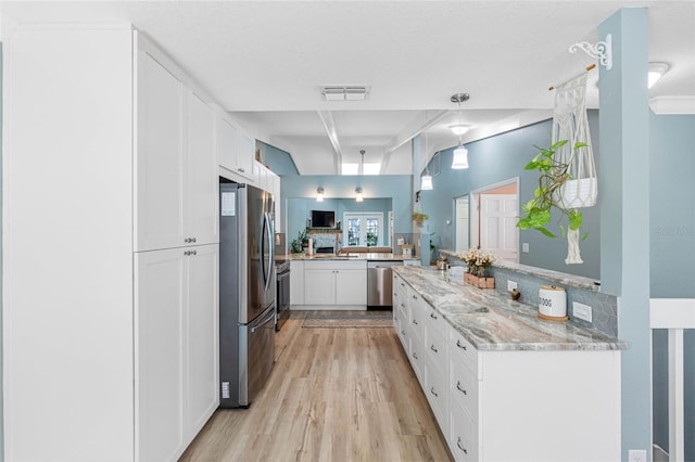 kitchen with appliances with stainless steel finishes, white cabinetry, light hardwood / wood-style floors, kitchen peninsula, and light stone counters