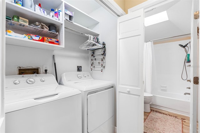 laundry area with washer and dryer and hardwood / wood-style flooring