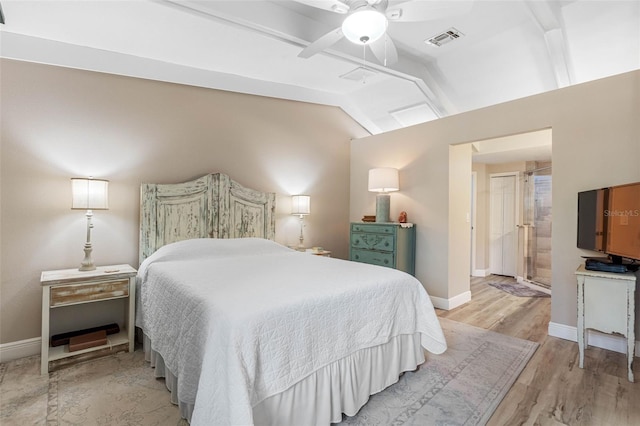 bedroom with vaulted ceiling, ceiling fan, and light hardwood / wood-style floors