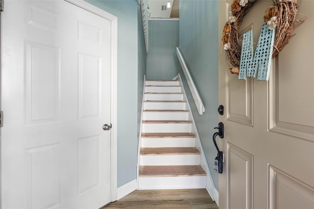 stairs with hardwood / wood-style flooring