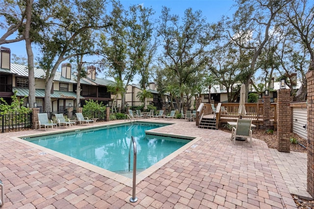 view of swimming pool with a deck and a patio area