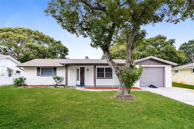 ranch-style house featuring a garage and a front lawn