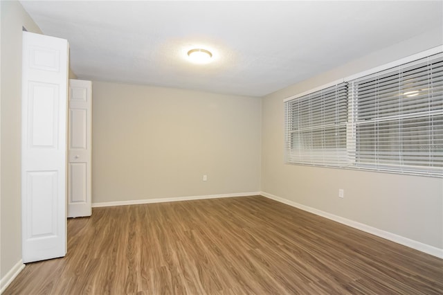 empty room with hardwood / wood-style flooring