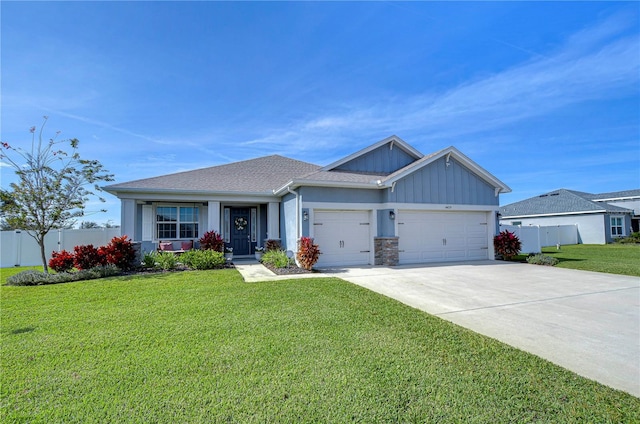 craftsman inspired home featuring a garage and a front lawn