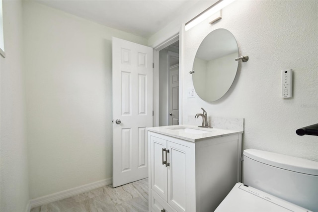 bathroom with toilet and vanity