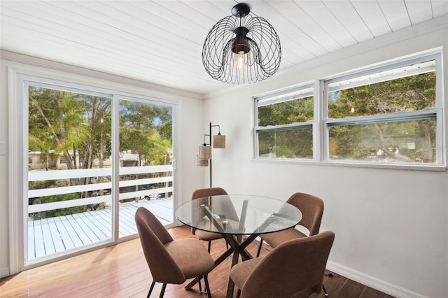 dining room with ornamental molding and light wood-type flooring