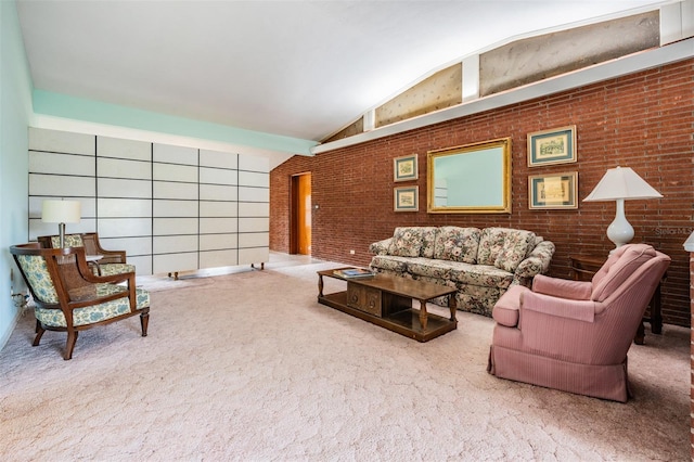 living room featuring brick wall, carpet flooring, and vaulted ceiling