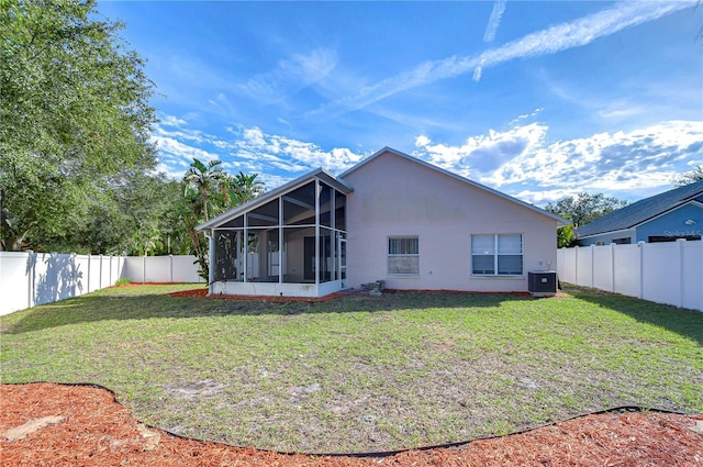 back of property featuring a yard and a sunroom