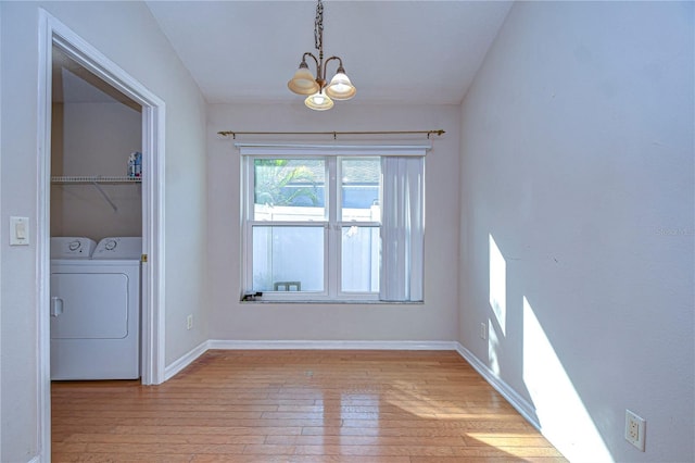 laundry room with separate washer and dryer, light hardwood / wood-style floors, and a chandelier