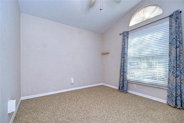 spare room with lofted ceiling, carpet floors, and ceiling fan