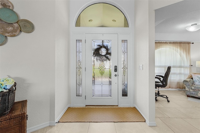 entrance foyer with baseboards and tile patterned floors