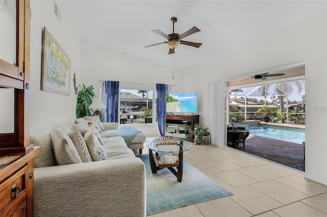 living room featuring lofted ceiling, light tile patterned floors, a sunroom, visible vents, and a ceiling fan