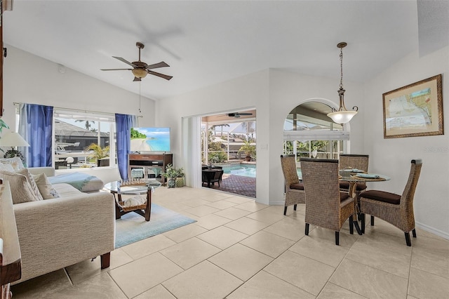 dining space featuring lofted ceiling, ceiling fan, and light tile patterned floors