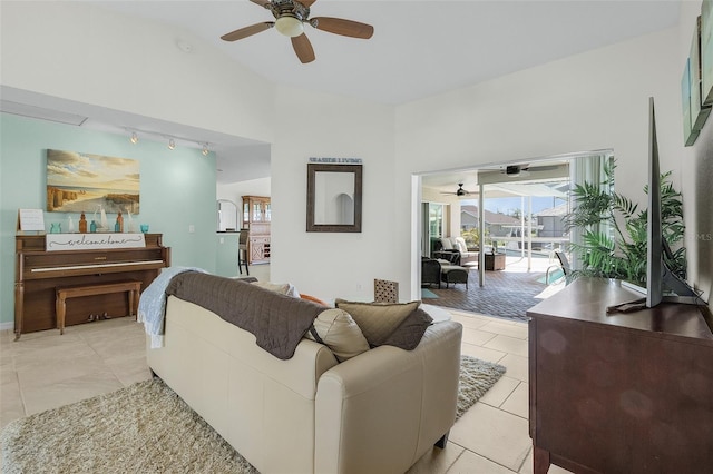 living area featuring a ceiling fan, rail lighting, and light tile patterned floors